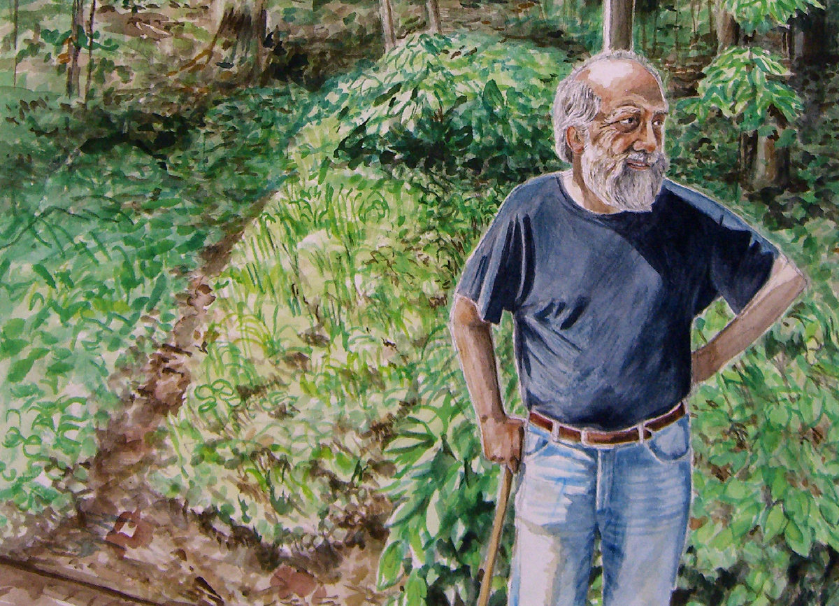Greene standing downhill from his writing hut.